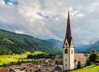 Trins mountaineering village аgainst the background of the Gschnitztal valley and the rainy sky in...