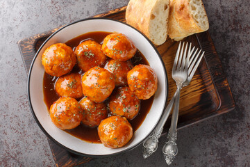 Spicy and sweet, chipotle honey glazed meatballs closeup on the bowl on the table. Horizontal top...