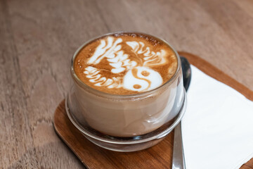 A cup of hot cappuccino, close up of a cappuccino with steamed milk foam.