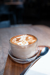 A cup of hot cappuccino, close up of a cappuccino with steamed milk foam.