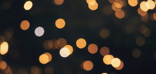 Obraz premium A scattering of golden bokeh highlights on a dark background