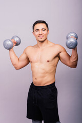Shirtless bodybuilder showing his great body and holding dumbell.