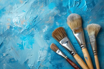 Paintbrushes On Blue Grunge Background With Copy Space For Artistic Expression