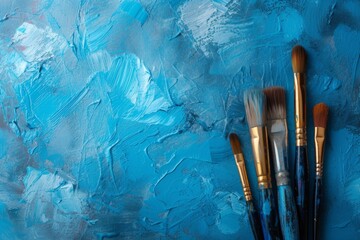 Artistic Expression With Paintbrushes On Blue Grunge Background