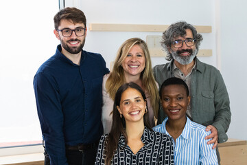 Cheerful diverse coworking people looking at camera