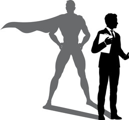 A superhero business man revealed by his shadow silhouette as a super hero in a cape