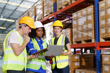 team of warehouse personnel is conducting a comprehensive stock inventory using laptop computers...
