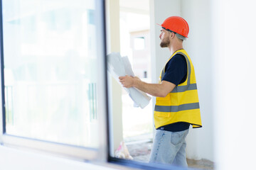 foreman checking the under construction building. Caucasian male engineer inspects interior.