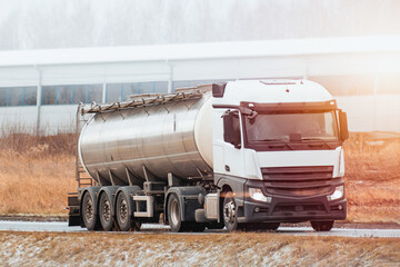 LPG Gas Delivery in Winter: A Tank Truck Driving on a Snowy Road with Caution and Safety
