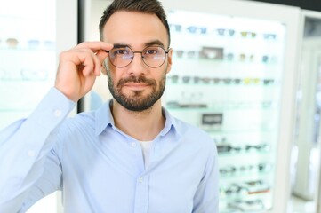 man chooses glasses for vision correction in an ophthalmology salon. Glasses for vision correction