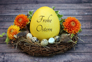 Grußkarte Frohe Ostern: Osternest mit Wachteleiern und einem beschrifteten Osterei.	
