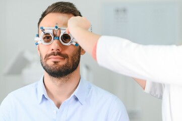 Ophthalmology concept. Male patient under eye vision examination in eyesight ophthalmological...