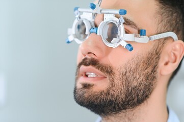 man checking up vision with special ophthalmic glasses
