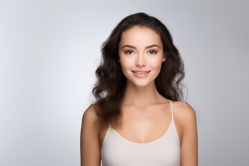 Sweet young girl dressed in comfortable vest undergarments, exuding confidence as she poses gracefully on a pristine white surface. Generative AI.