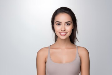 Sweet young girl dressed in comfortable vest undergarments, exuding confidence as she poses gracefully on a pristine white surface. Generative AI.