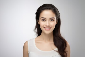 Fototapeta premium Sweet young girl dressed in comfortable vest undergarments, exuding confidence as she poses gracefully on a pristine white surface. Generative AI.