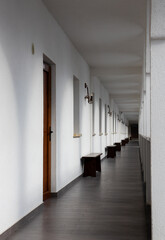 A long straight corridor with white walls