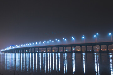 Scenic view of the city of Dnepr in the winter evening. Dnipro in the evening. Ukrainian city in winter at night. background image. Panoramic view. Long exposure photo of the Dnieper River at night.