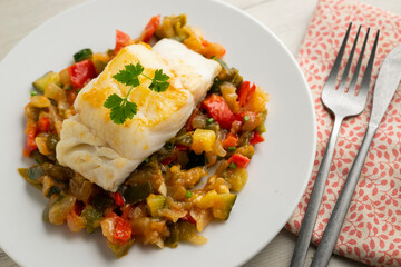 Cod tapa cooked with vegetables in samfaina. Traditional recipe of Spanish gastronomy.