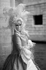 Venice, Italy - February 2024 - carnival masks are photographed with tourists in San Marco square