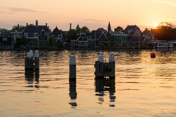 Windmills silhouettes in the beautiful village of Zaanse Schans in Netherlands at sunset