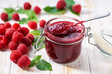 Delicious raspberry jam on table close-up, selective focus.