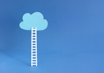 Authentic business career ladder image showing a paper ladder leading to a floating cloud on blue...