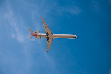 Milan, Italy 6.12.2023 Airplane in the sky, Passenger Airliner. Airplane flying on blue sky.