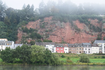 Fototapeta na wymiar the red cliffs at the Mosel in Trier with fog
