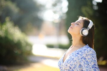 Woman breathing and meditating listening audio guide