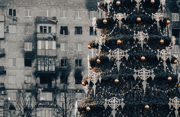 Christmas tree with toys near the house in the ruined city in Ukraine