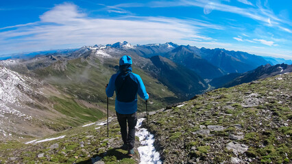 Hiker man with scenic view of majestic mountain peaks of High Tauern seen from Feldseekopf,...