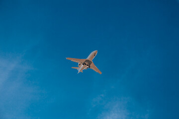 Italy, Milan, San Donato Milanese 14.12.2023. Low flying plane landing at the airport Linate. Airplane against blue sky.