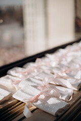 Preparation of table setting for the event. Many
napkins folded and tied with ribbon