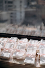 Preparation of table setting for the event. Many
napkins folded and tied with ribbon
