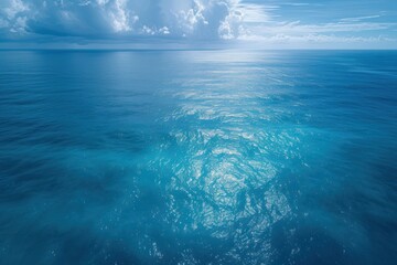 Fototapeta na wymiar Aerial view of a blue sea surface water texture background and sun reflections Aerial flying drone view Waves water surface texture on sunny tropical ocean in Phuket island