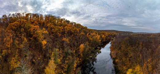 Fototapeta na wymiar Aerial panorama autumn river with clouds reflection on water. Wild autumnal riverside nature in Ukraine