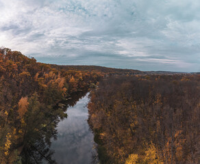 Aerial autumn river landscape and cloudy sky. Wild autumnal riverside nature in Ukraine