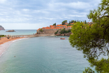 Sveti Stefan island in Montenegro resort at Adriatic sea, pine tree and beach view