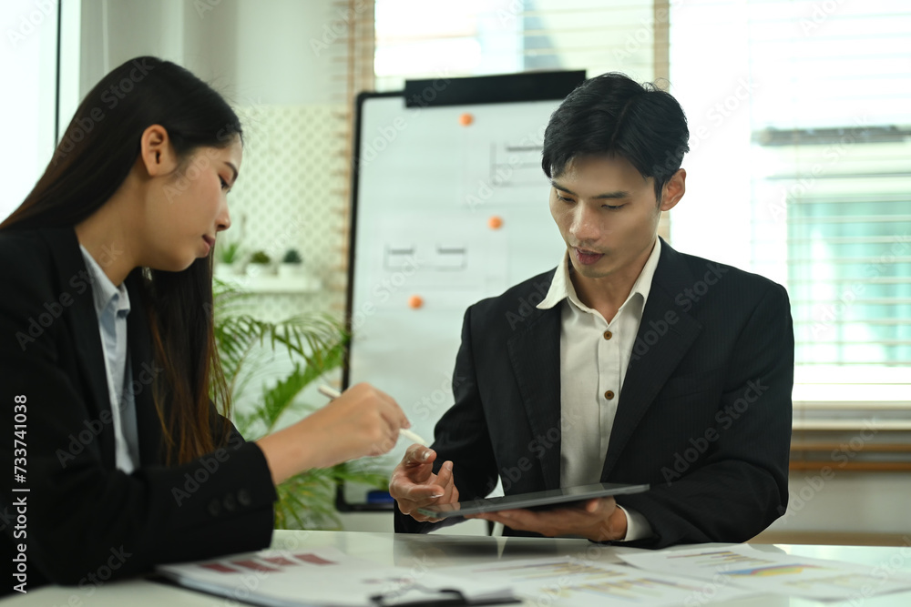 Poster business team using digital tablet and discussing project strategy at co working office space