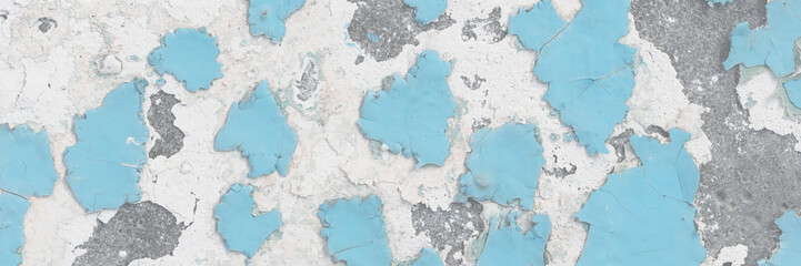 Blue peeling paint on the wall. Old concrete wall with cracked flaking paint. Weathered rough...