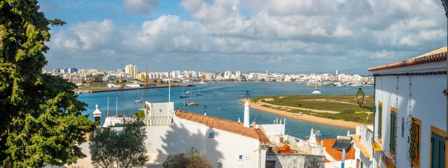 View of the Arade river and the city of Portimão from the historical fishing village of Ferragudo, Lagoa, Algarve, Portugal