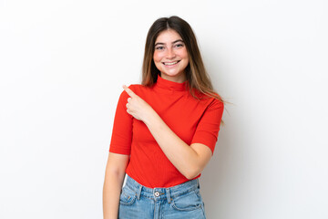 Fototapeta premium Young caucasian woman isolated on white background pointing to the side to present a product