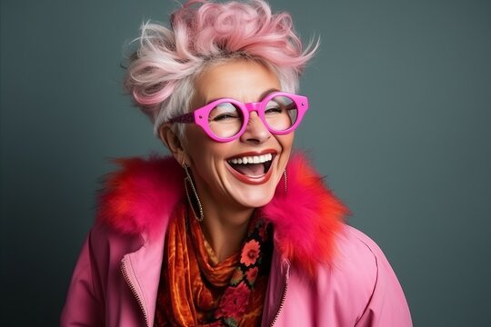 Portrait of a beautiful young woman with pink hair and pink glasses.