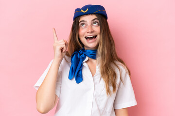 Airplane stewardess caucasian woman isolated on pink background intending to realizes the solution while lifting a finger up