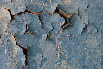 Peeling paint on the wall. Old concrete wall with cracked flaking paint. Weathered rough painted...