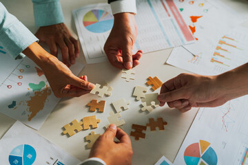 Innovative business team engages in successful brainstorming, piecing together the jigsaw of...
