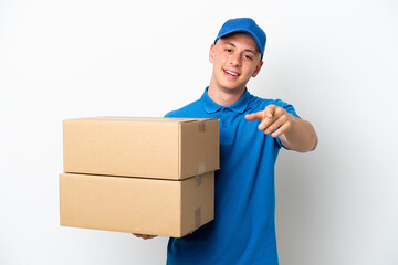 Young delivery Brazilian man isolated ops white background surprised and pointing front