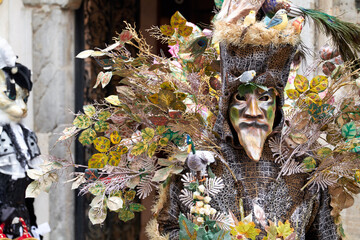 Venice, Italy - February 2024 - carnival masks are photographed with tourists in San Marco square