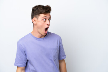 Fototapeta premium Young handsome Brazilian man isolated on white background doing surprise gesture while looking to the side